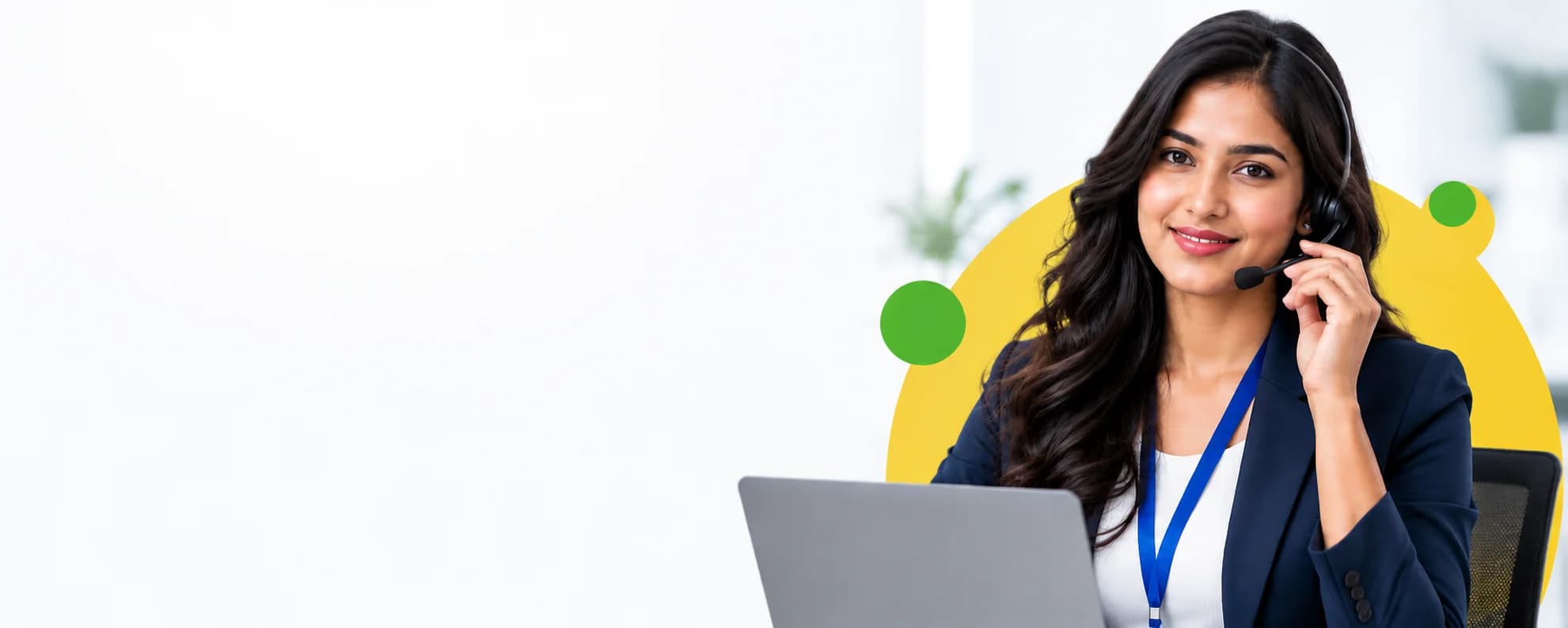 Customer support representative wearing a headset and sitting behind a laptop