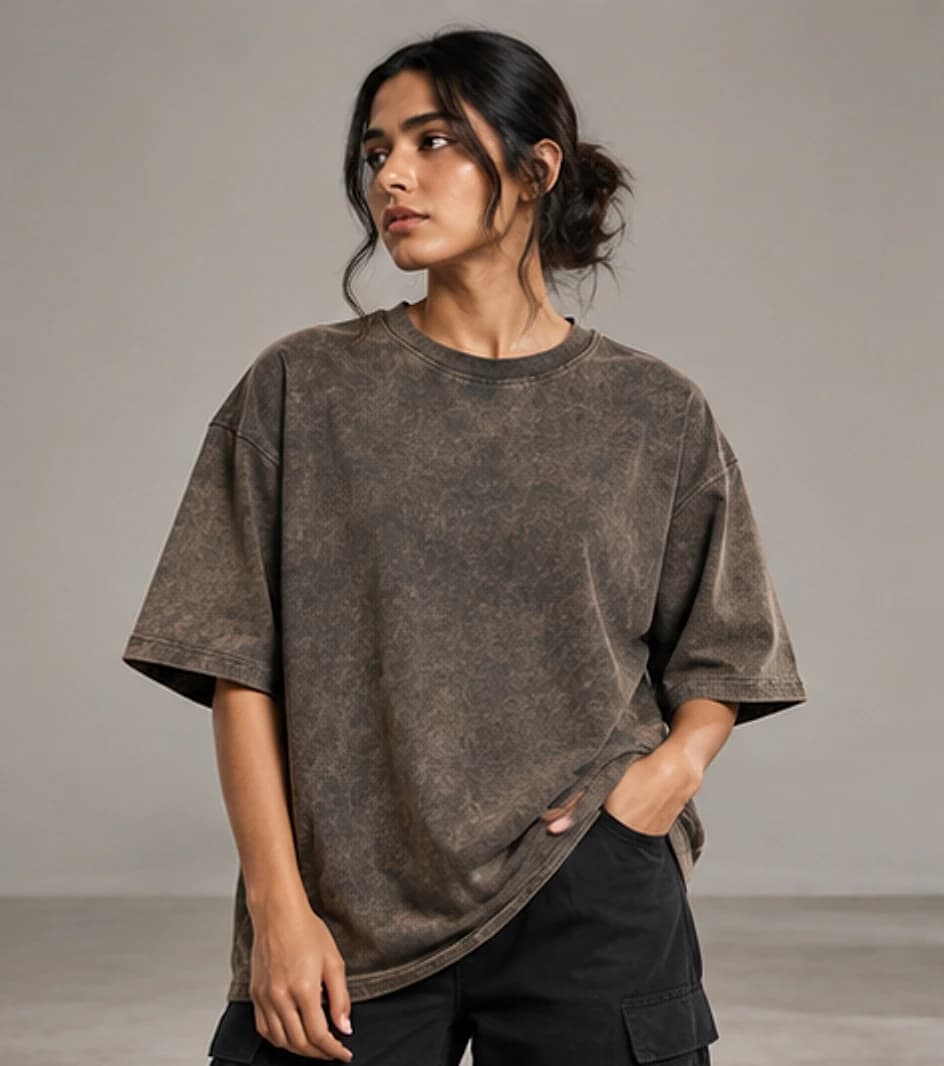 Acid-washed garment-dyed oversized tee with a worn finish on model