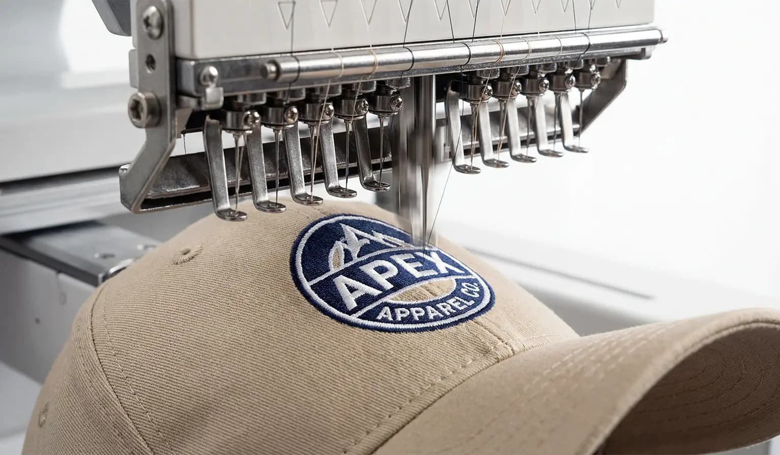 Multi-needle head stitching a logo into a cap crown