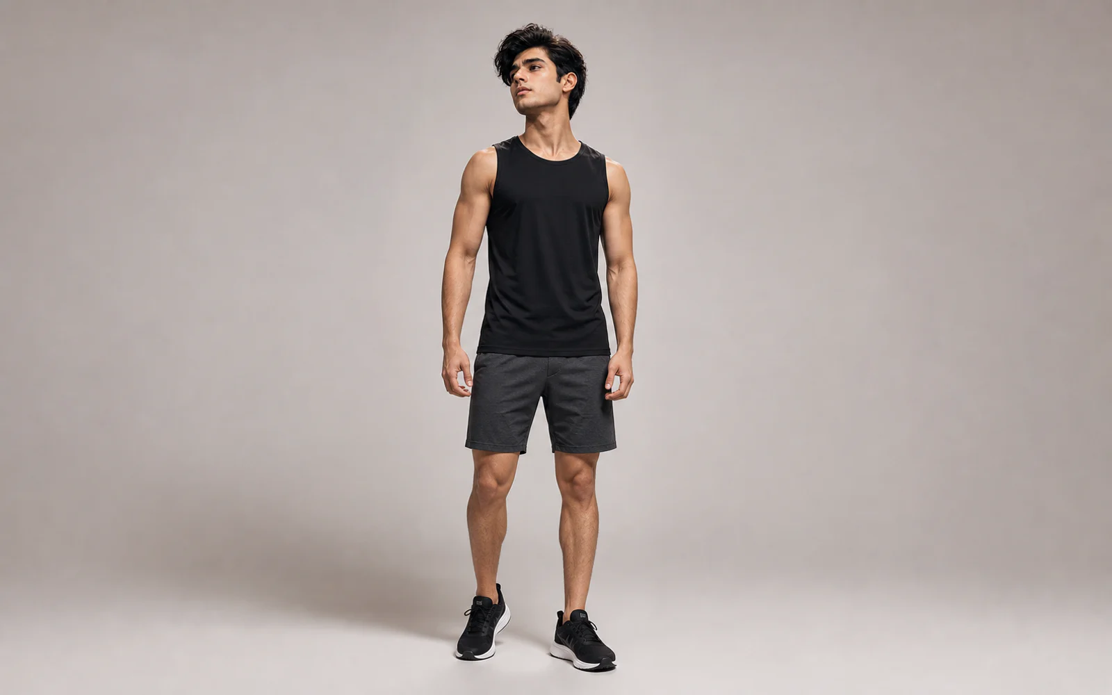 Male model wearing an unbranded moisture-wicking workout tank and training shorts